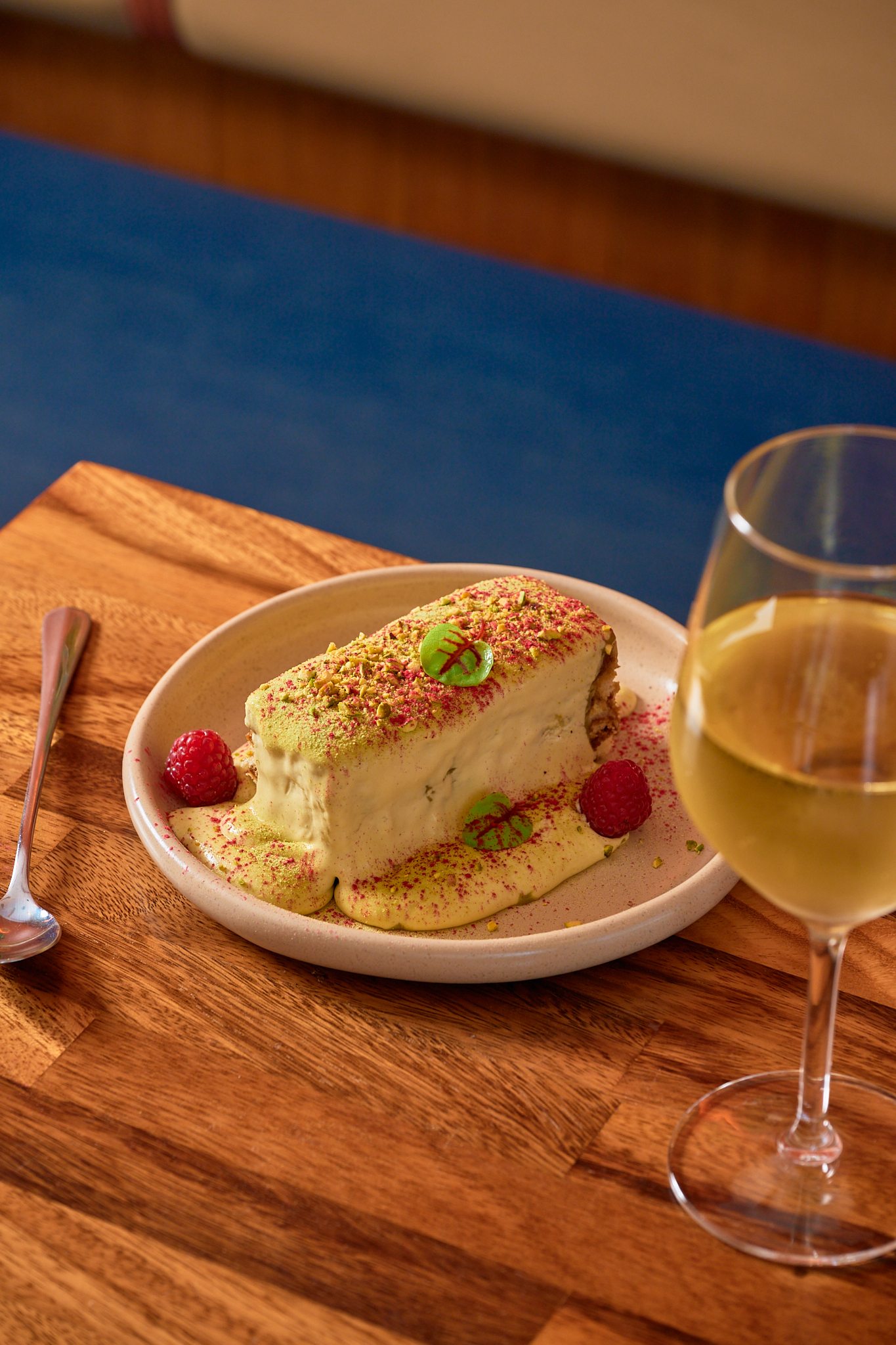 Layered dessert with wine on a timber table